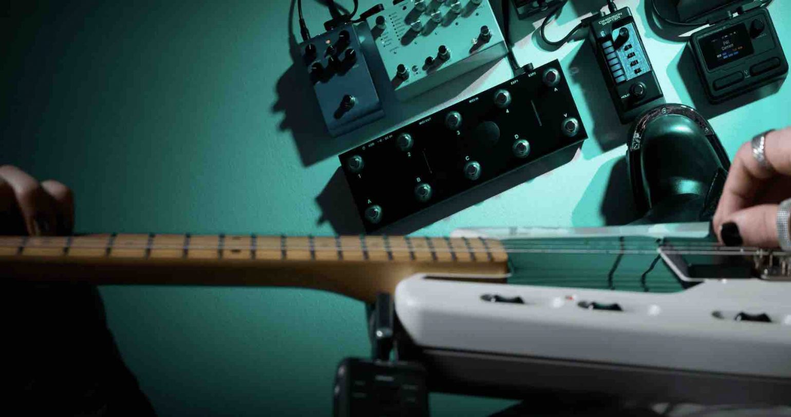 Casio Dimension Shifter wireless expression controller mounted on a guitar strap with its companion Casio Dimension Shifter wireless expression controller mounted on a guitar strap with its companion floor receiver..