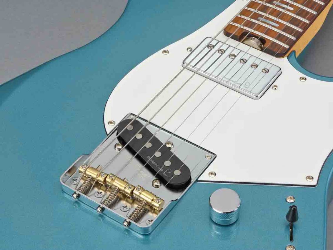Close-up of the Yamaha Reflectone pickups co-developed with Rupert Neve Designs, showing the single-coil bridge and humbucker neck configuration on a Pacifica SC.