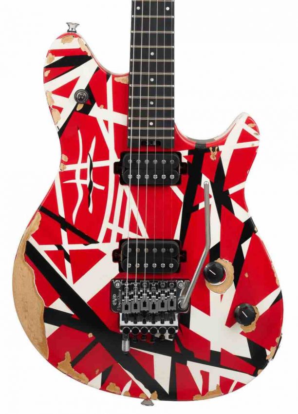 Close-up of direct-mount EVH Wolfgang humbucking pickups and distressed chrome hardware on an aged striped finish guitar body.