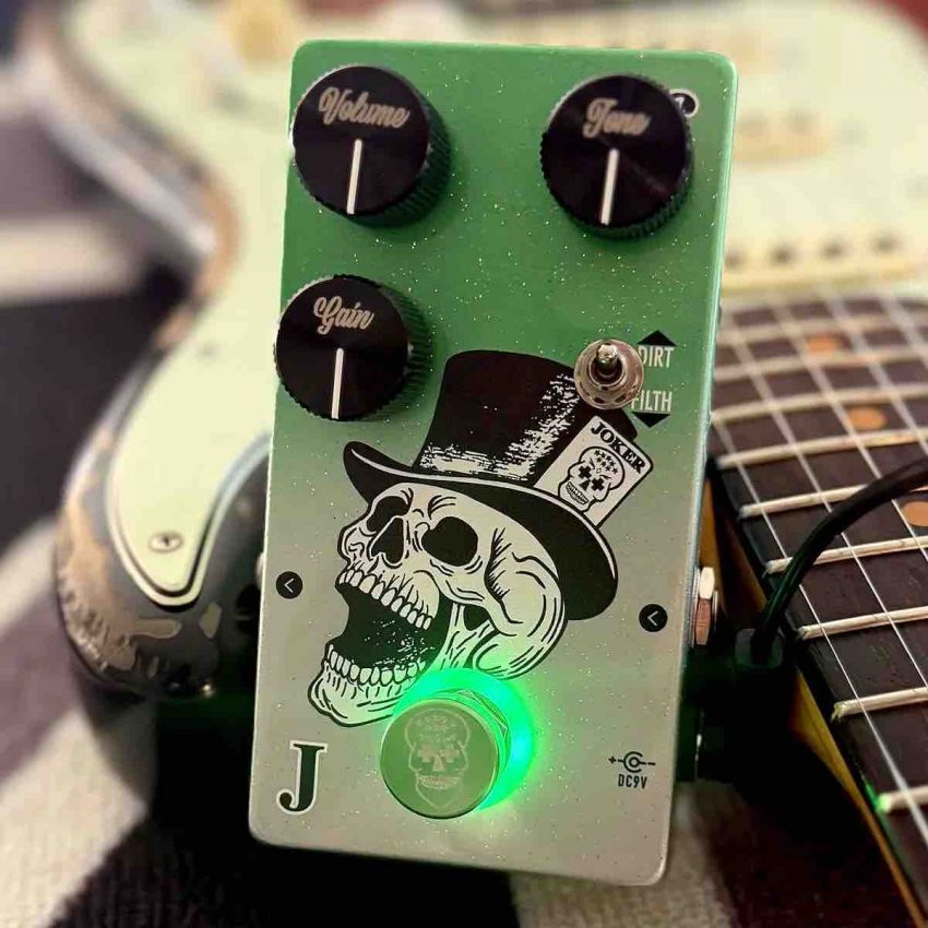 Flattley Pedals The Joker valve tone stompbox featuring a green burst holographic metal flake finish with custom etched aluminium knobs and a green halo light ring.