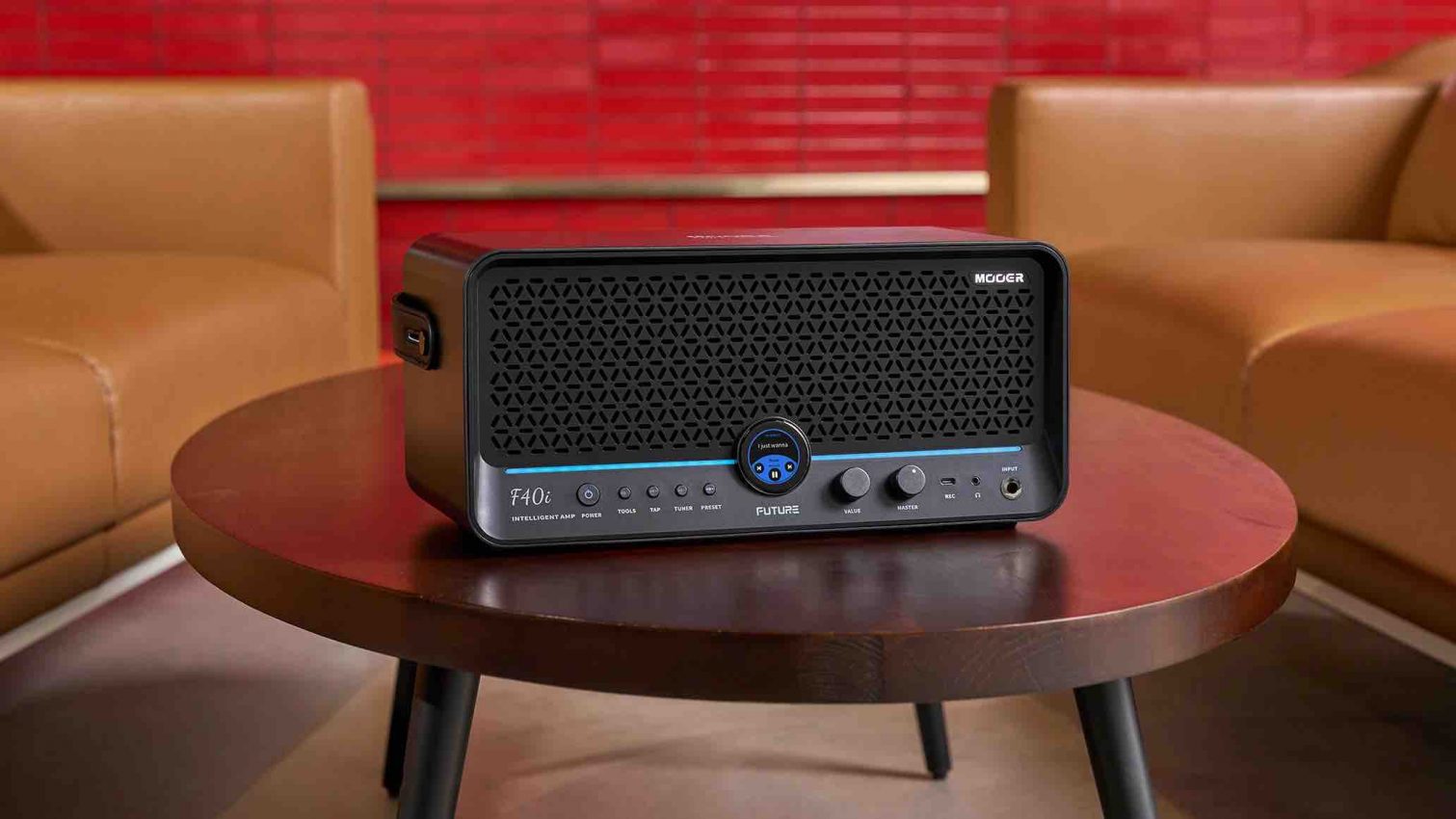 Mooer F40i intelligent desktop guitar amplifier in Phantom Black featuring a circular touchscreen and dual 4-inch speakers.