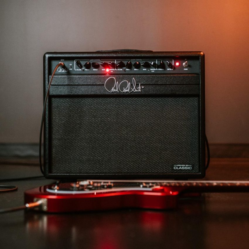 Front view of the PRS Archon Classic 50W 1x12 Valve Amp Combo featuring black textured vinyl, retro-inspired control knobs, and the iconic PRS signature logo.