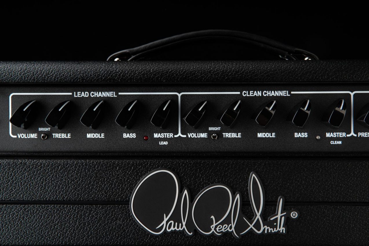 Close-up of the PRS Archon Classic control panel showing the individual 3-band EQs, Bright switches, and Global Presence and Depth knobs for precision tone shaping.