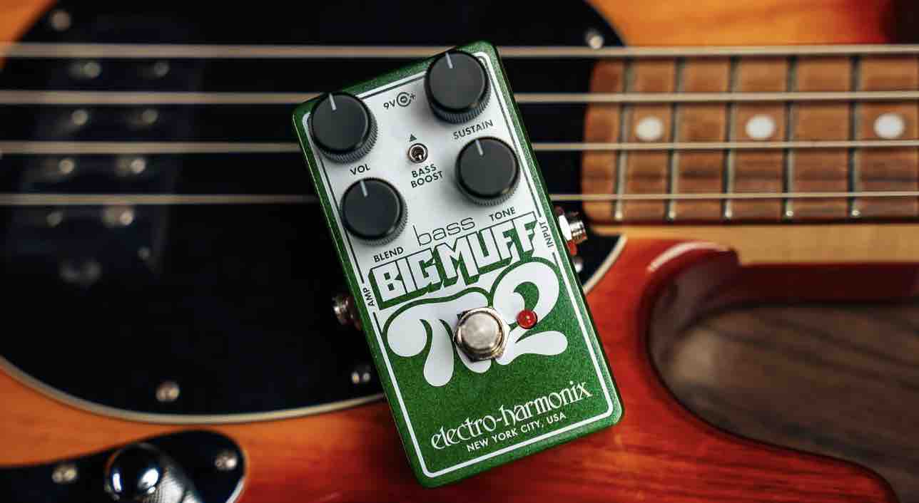 Front view of the Electro-Harmonix Bass Big Muff Pi 2 pedal in a compact Nano chassis, featuring knobs for Volume, Tone, Sustain, and Blend, along with a Bass Boost switch and a silver footswitch on a black and green metallic housing.