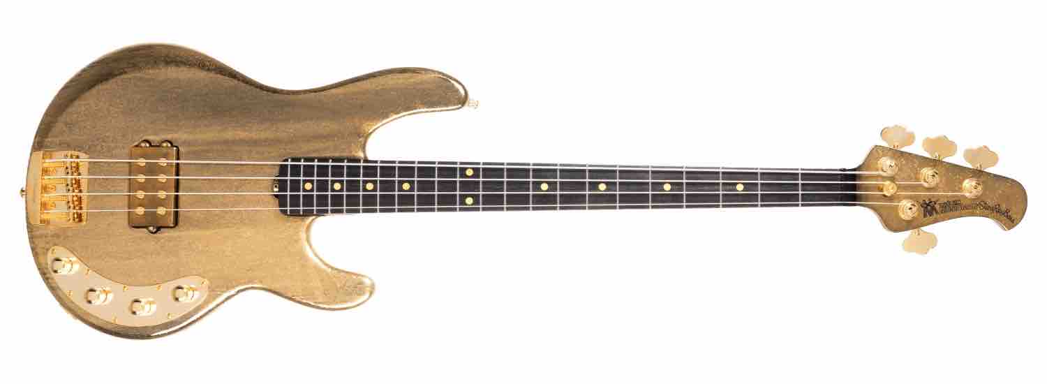 Limited-edition Ernie Ball Music Man 50th Anniversary StingRay bass in Molten Gold finish showing the matching headstock and gold hardware