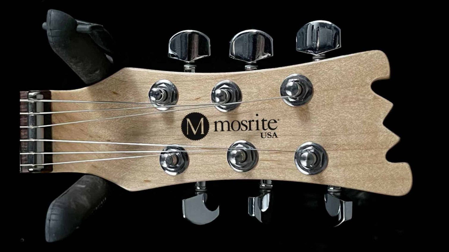 Close-up of the Mosrite Mark II headstock featuring the iconic logo, vintage-style tuners, and signature zero fret.