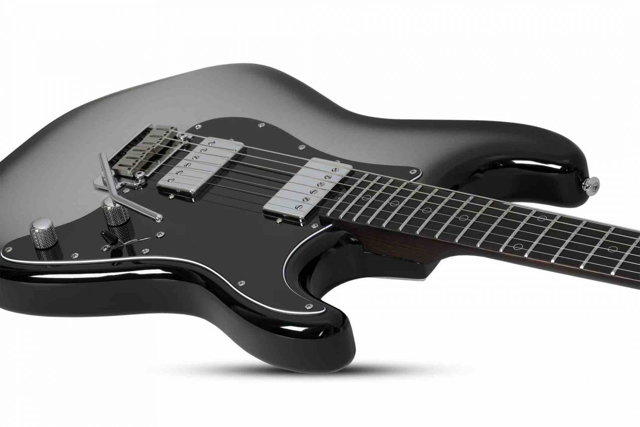 Schecter Nick Johnston Signature Traditional HH electric guitar in Atomic Mercury silver burst finish featuring a wenge neck, ebony fretboard, and dual Atombucker pickups.