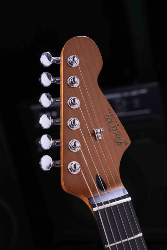 Detailed shot of stainless steel frets and bone nut on a Patina Guitar neck for improved durability and tone."