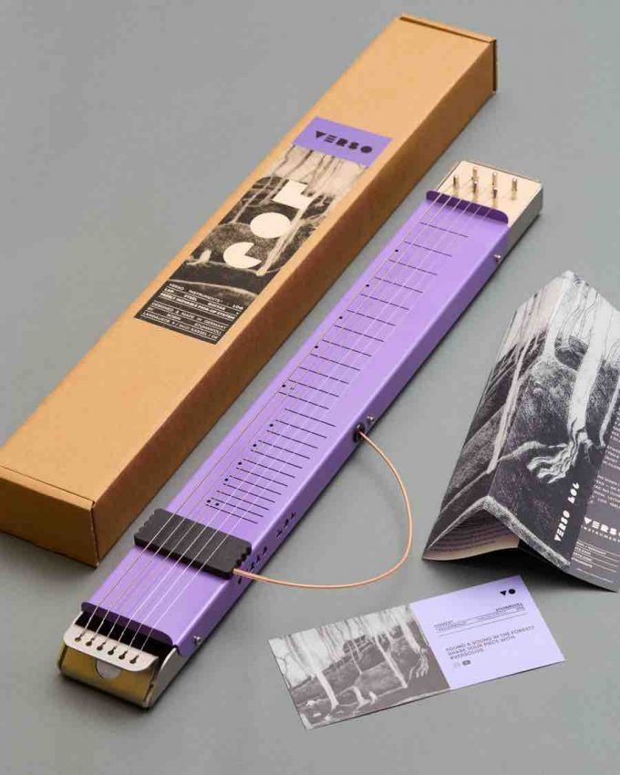 Top-down view of the Verso Log lap steel guitar in Pop Lilac with a stainless steel base and movable magnetic pickups on a 22.5-inch scale.