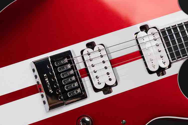 Solar Guitars S1.6RS CAR electric guitar in Candy Apple Red with white racing stripes, featuring EverTune bridge and Seymour Duncan pickups.
